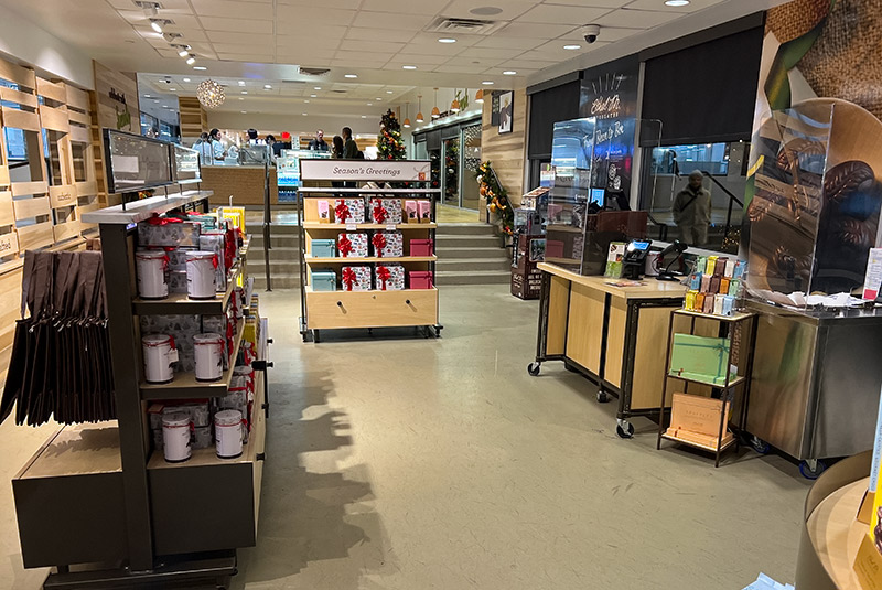 Shelves filled with holiday gift boxes inside the entrance of Ethel M Chocolates.